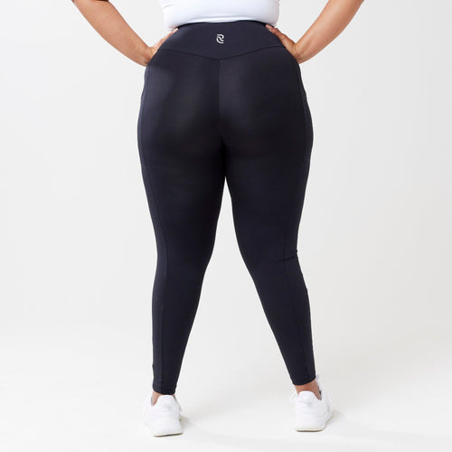 Plus model wearing black leggings for use in active lifestyles as well as casual living.