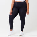 Plus model wearing black leggings for use in active lifestyles as well as casual living.