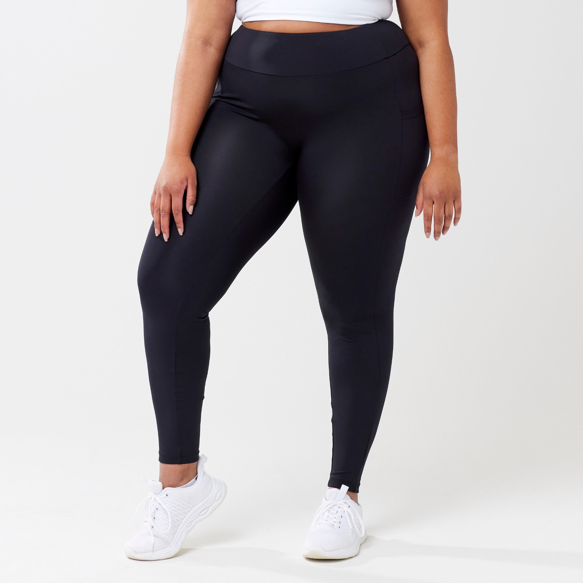 Plus model wearing black leggings for use in active lifestyles as well as casual living.