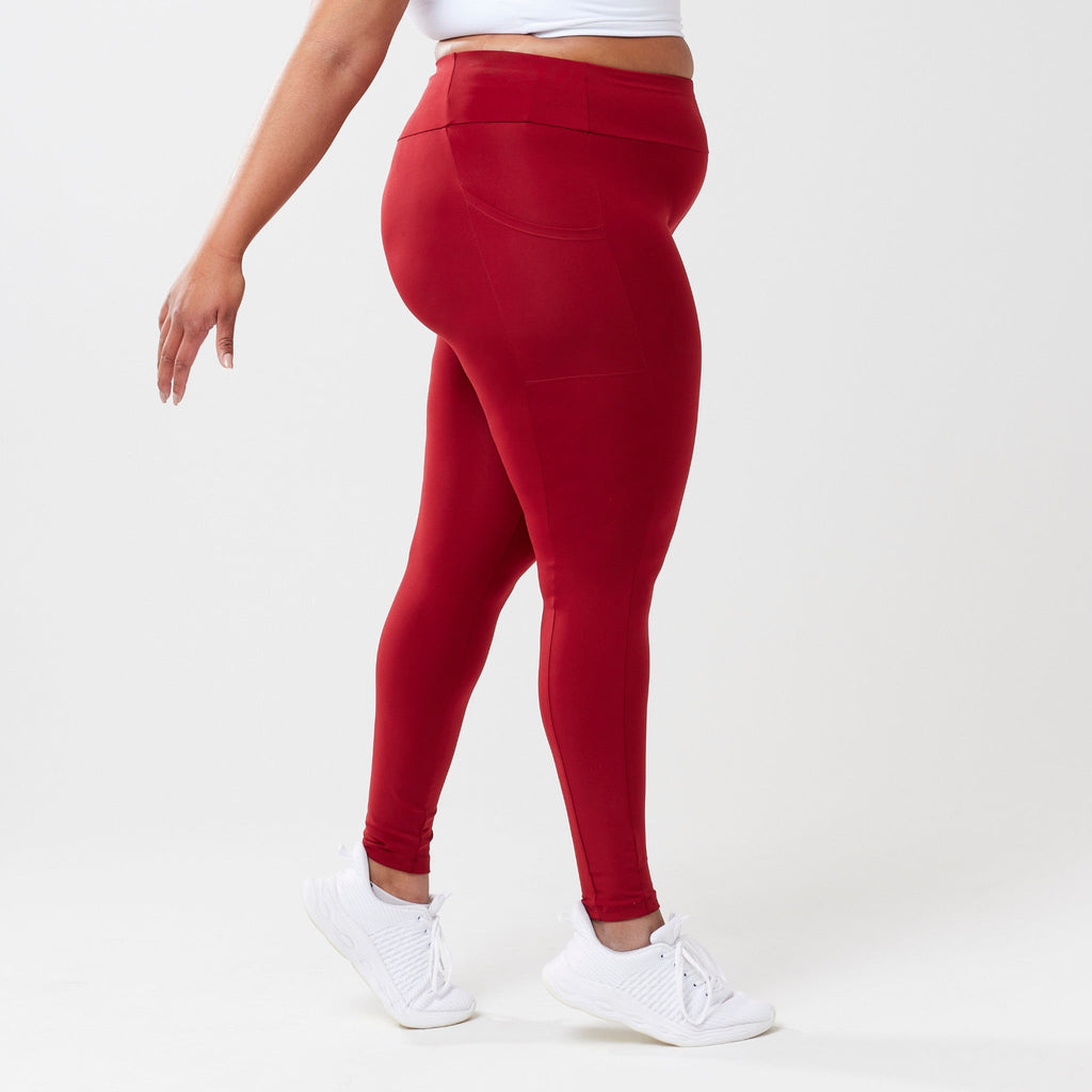 Plus model wearing red leggings for use in active lifestyles as well as casual living.