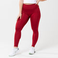Model wearing red leggings for use in active lifestyles as well as casual living.